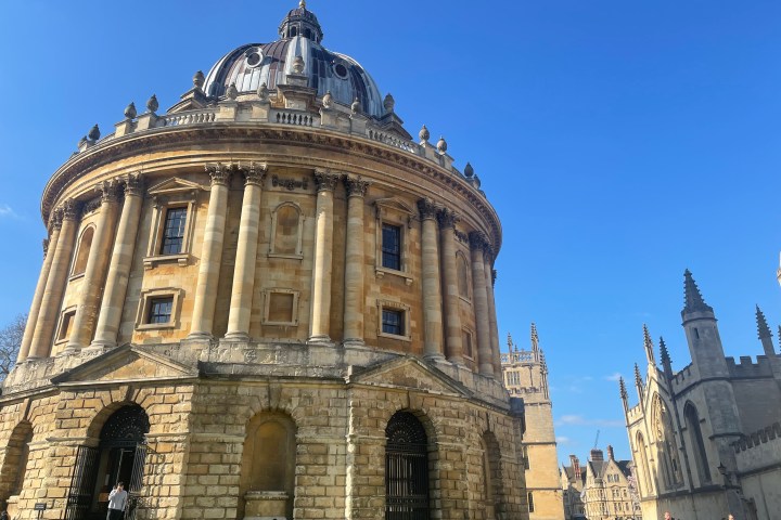 a large tall tower with a clock at the top of Bodleian Library